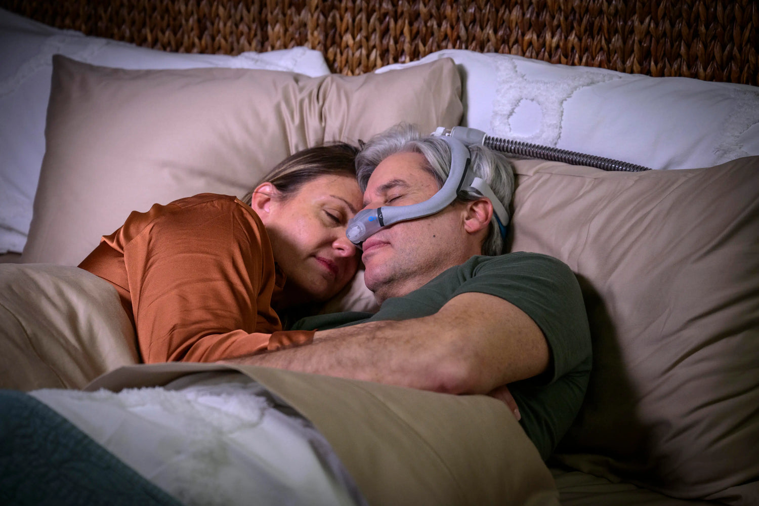 A man sleeping using cpap mask with his wife