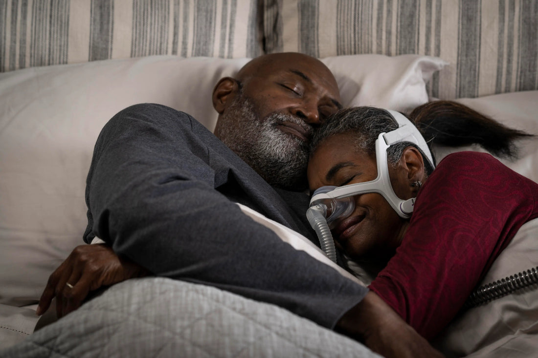 Married couple sleeping together while wife is using the machine
