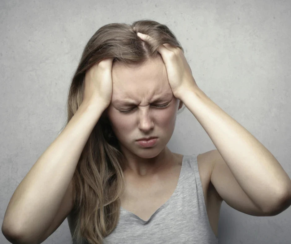 Woman in Gray Tank Top Showing Distress from headache