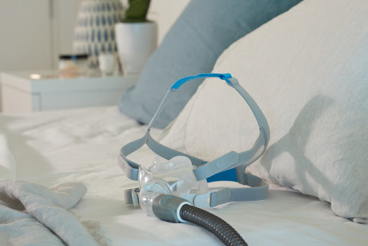 The ResMed AirFit F30 Full Face CPAP Mask on a bed