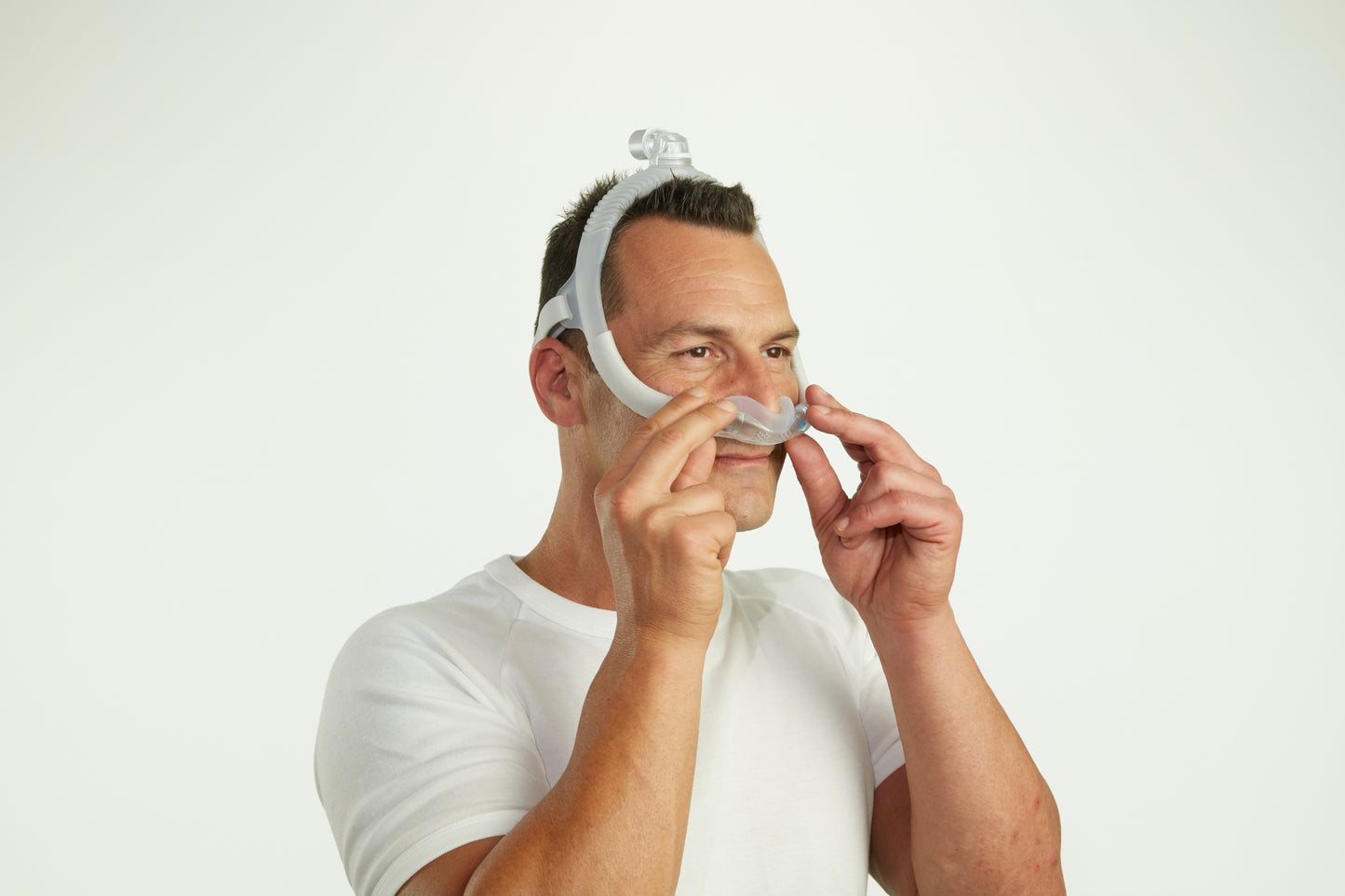 A man wearing the AirFit N30i Nasal CPAP Mask