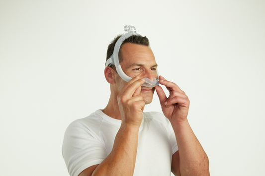 A man wearing the AirFit N30i Nasal CPAP Mask