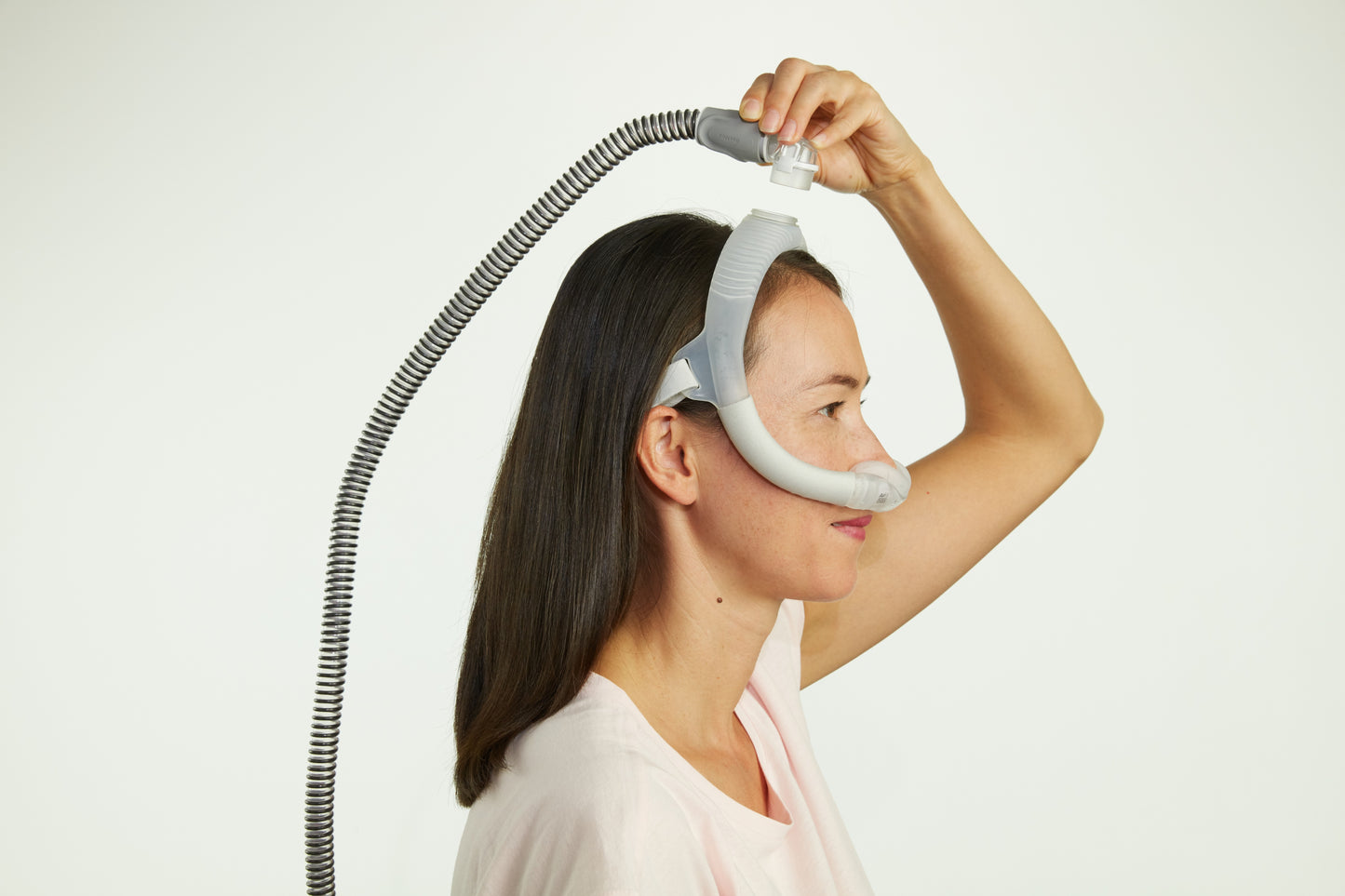 A woman wearing the AirFit N30i Nasal CPAP Mask