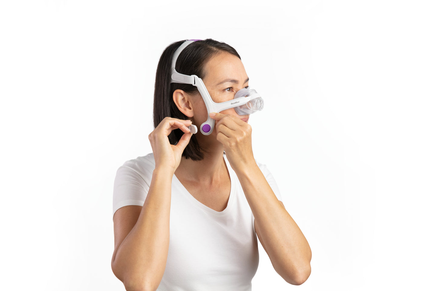 A woman trying on the AirTouch N20 Nasal CPAP Mask For Her