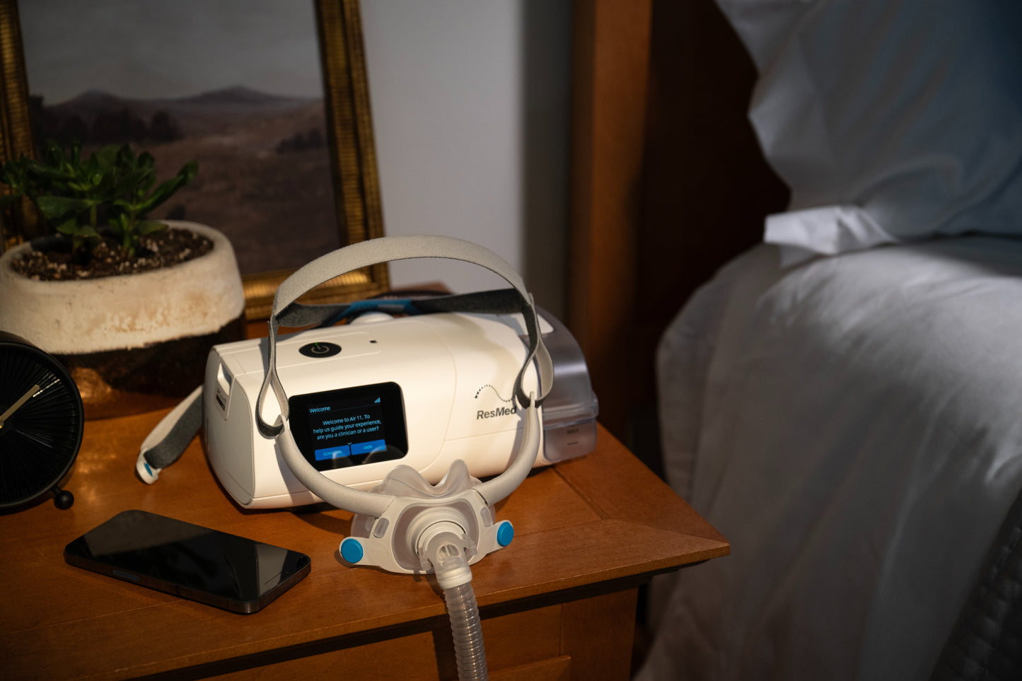 The ResMed AirCurve 11 VAuto BiLevel Machine with HumidAir and Heated Humidifier on a wooden bedside table