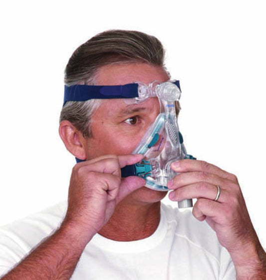 A guy fitting ResMed Mirage Quattro Full Face CPAP Mask