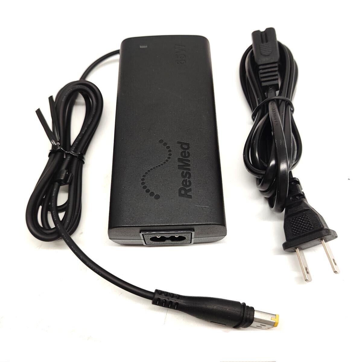 The black ResMed AirSense 10 Power Supply with cord carefully organized.