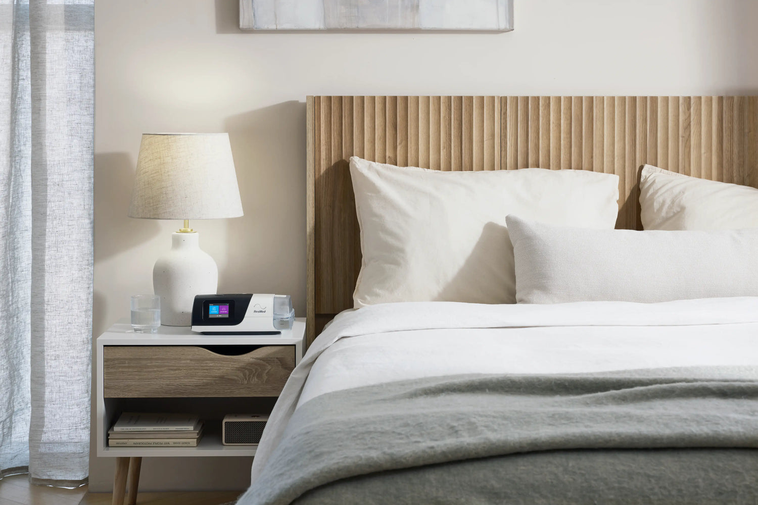 A CPAP machine in the table beside the bedroom