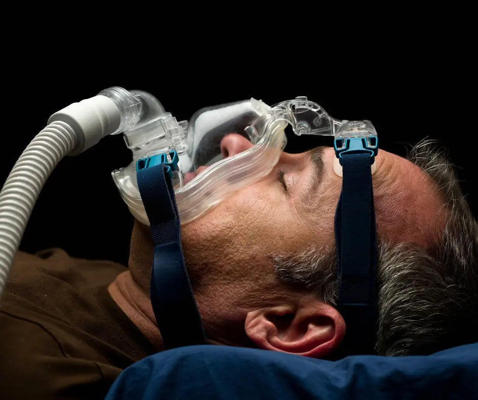 Man wearing a CPAP mask while sleeping. 