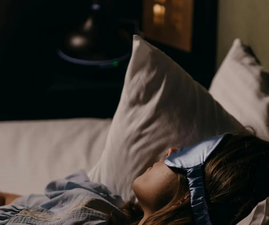  A woman sleeping soundly with an eye mask on.