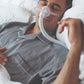 A man sleeping soundly wearing the Wisp Nasal CPAP Mask