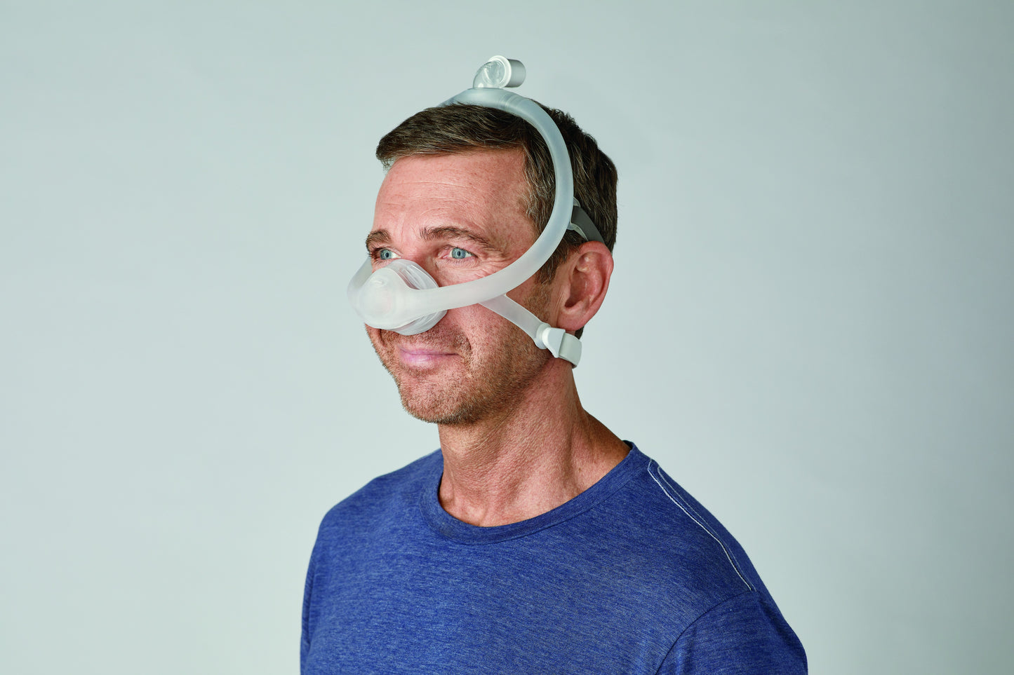 a man comfortably wearing DreamWisp Nasal CPAP Mask