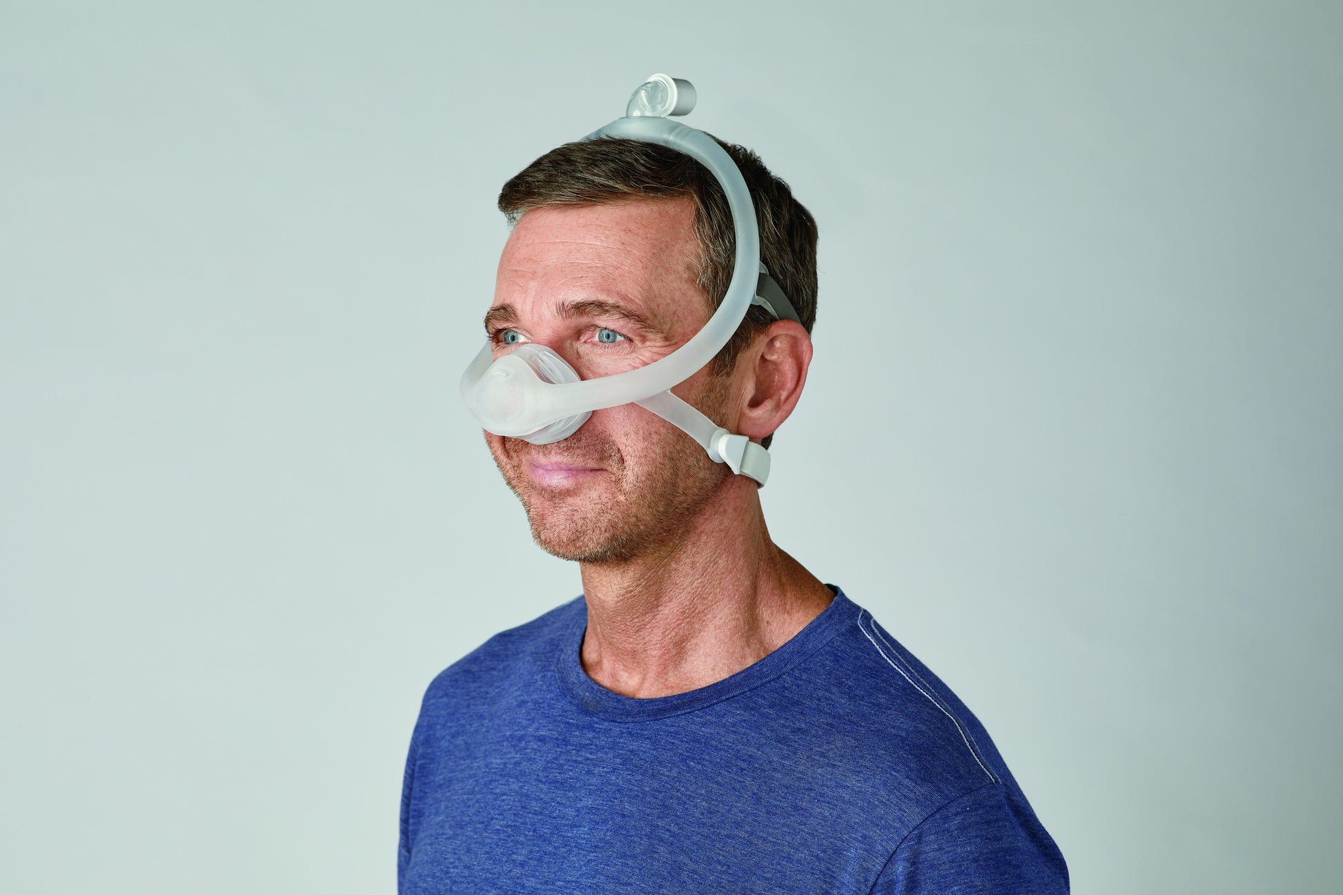 a man comfortably wearing DreamWisp Nasal CPAP Mask