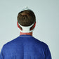 the back view of a man's head wearing a CPAP Mask