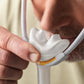Man using the Fisher & Paykel Solo Nasal Pillow Mask with a gray background