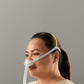 Woman wearing the Fisher & Paykel Solo Nasal Pillow Mask against a gray background